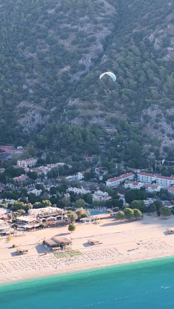 Paragliders gliding above Belcekız beach