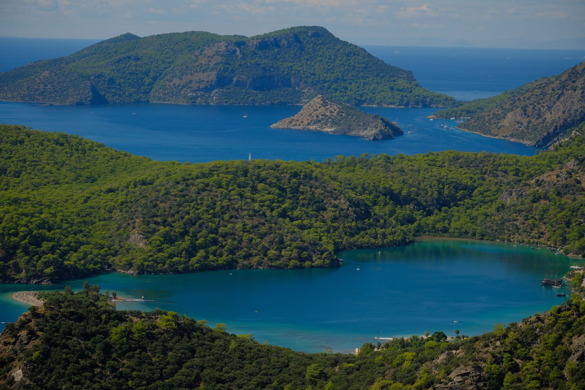 The blue lagoon of Ölüdeniz and its pine forest from above